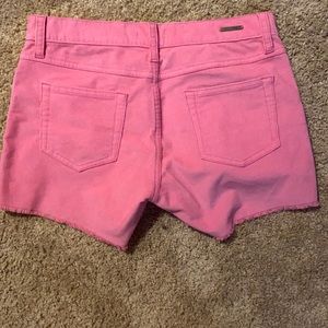 Pink jean shorts from Carve Designs.